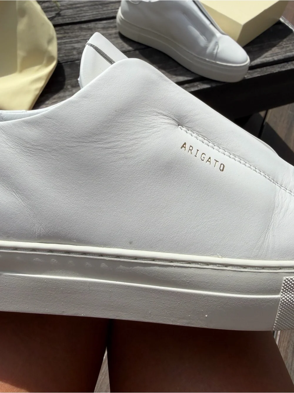 Axel Arigato White Leather Slip-On Sneakers with Gold Logo